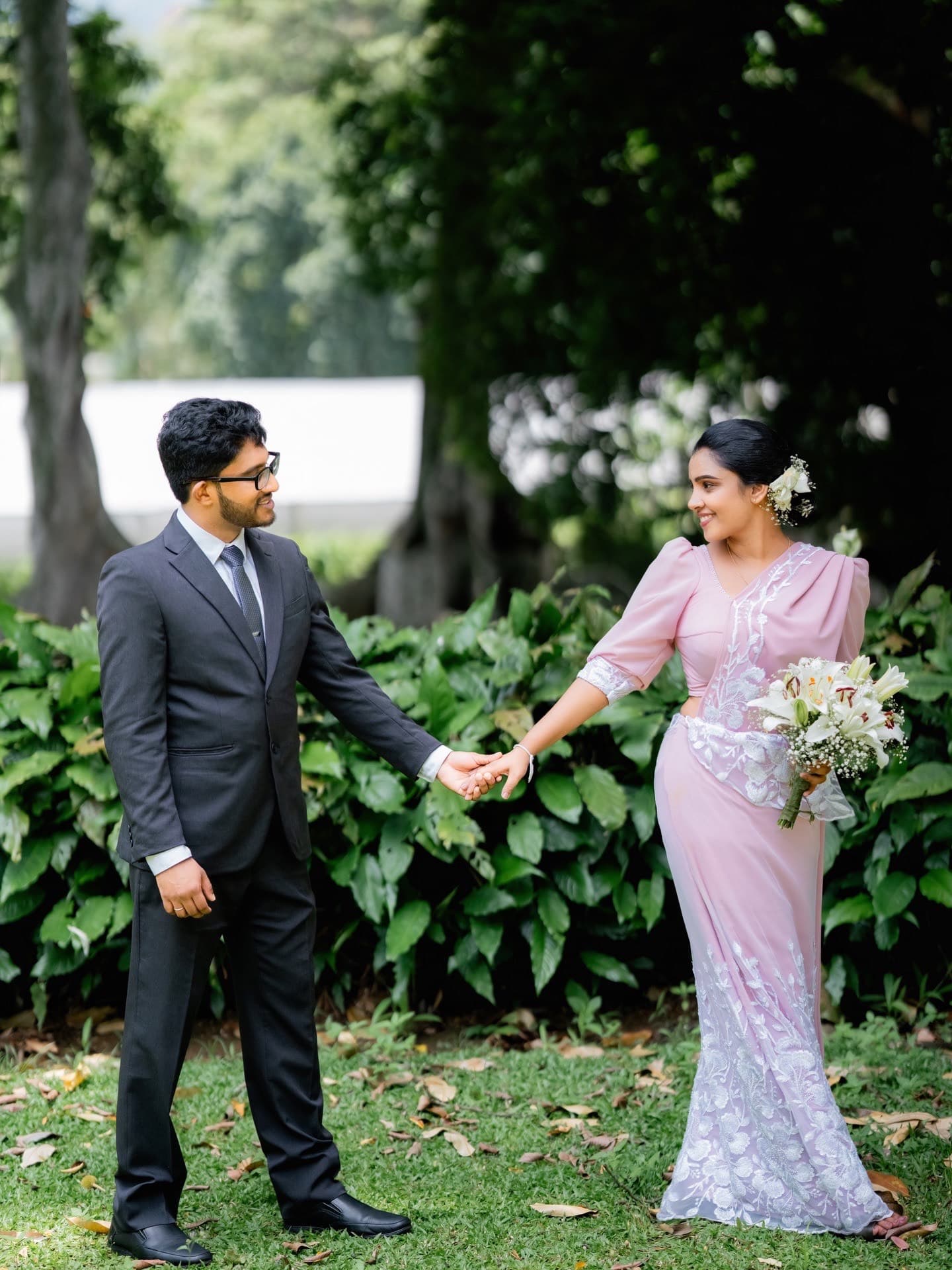 Hiruni and Ravindu holding hands in the garden